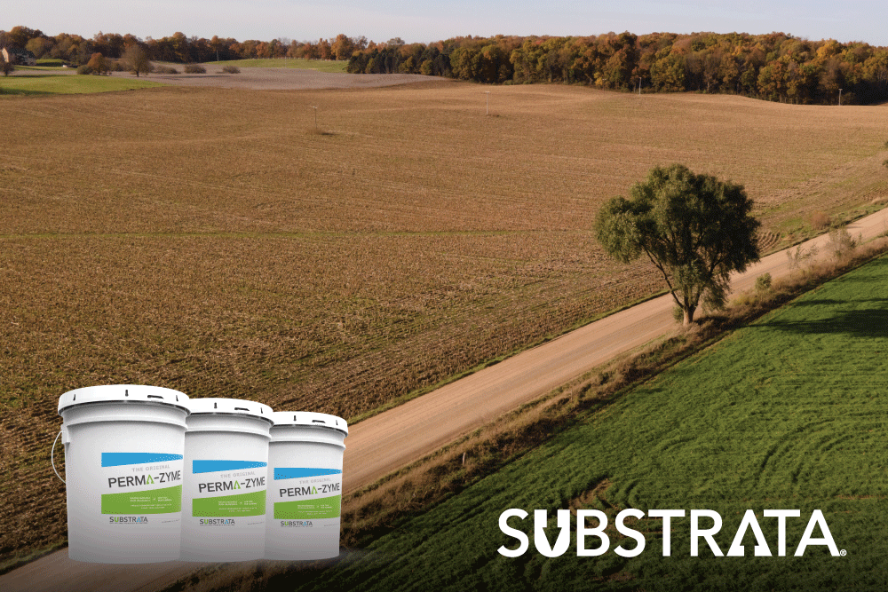 Perma-Zyme pails along a stabilized rural, dirt road