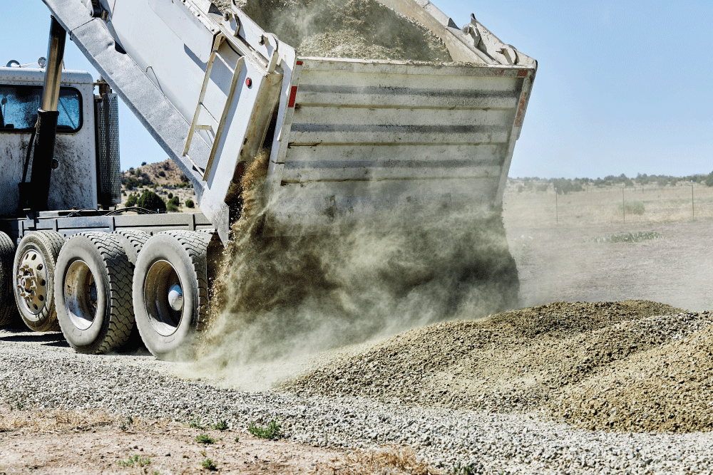 Dump truck dumping out gravel aggregate