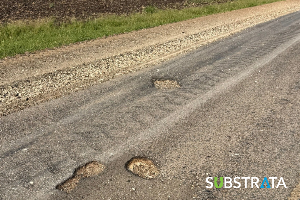 Grayson County chipseal road with potholes and rutting