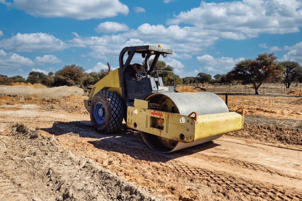 Smooth wheel compactor on a dirt road