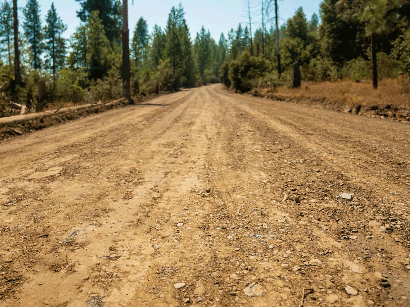 Straight view showing completed stretch of Maripos County road treated with Perma-Zyme