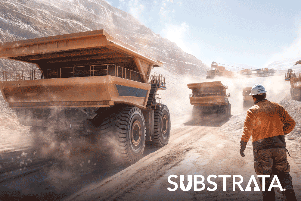 Haul trucks kicking up fugitive dust at a surface mine site