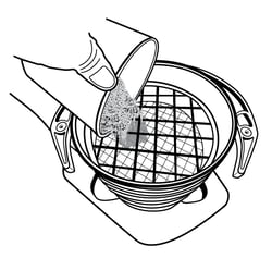 Lab tech pouring soil sample into the top of the sieve stack