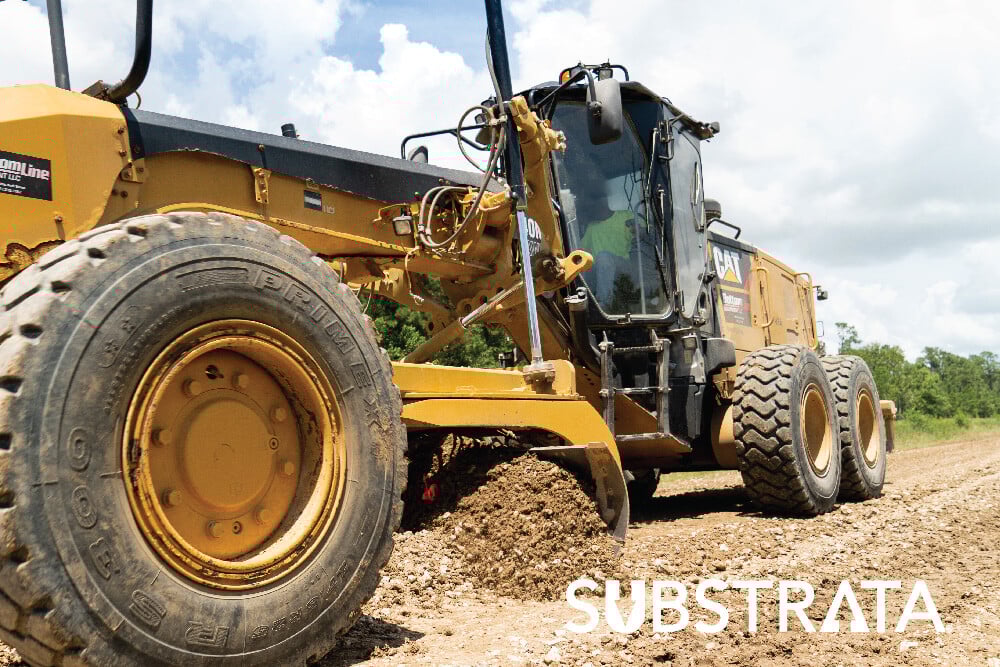 Motor grader working with expansive clay soil