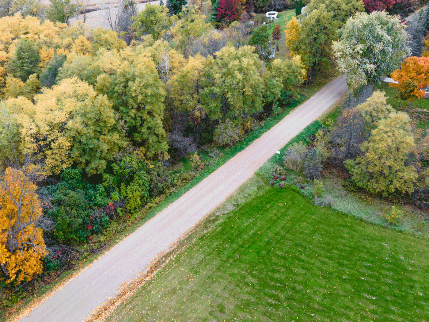 Overhead side view showing completed stretch of Atlas Township road treated with Perma-Zyme