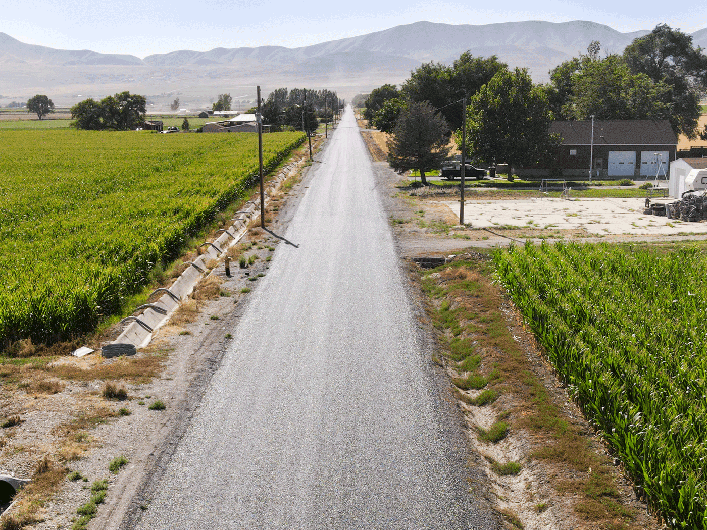 Aerial view showing completed stretch of Box Elder County road treated with Perma-Zyme and chipseal