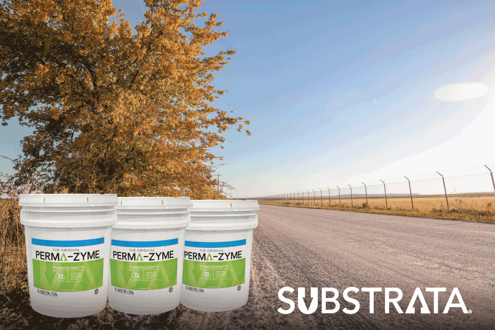 Three Perma-Zyme pails on a treated dirt road