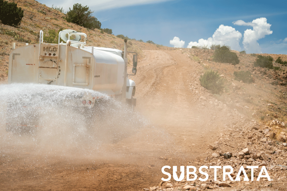 Water truck applying Perma-Zyme to stabilize an unpaved road