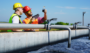 Workers at a wastewater treatment plant evaluating water quality